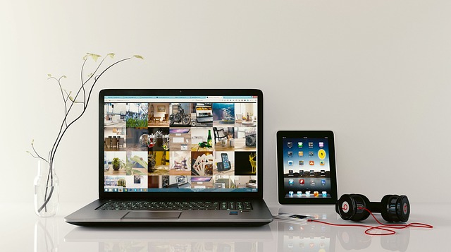 A laptop, tablet, and headphones on a table